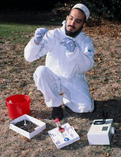 Dr Muffadal Ezzi, senior research scientist at CBS, tests soil for pollution using the innovative Safe Soil Tester™ developed jointly by NRI and CBS.  (photo © Brian Bell, London Press Service)