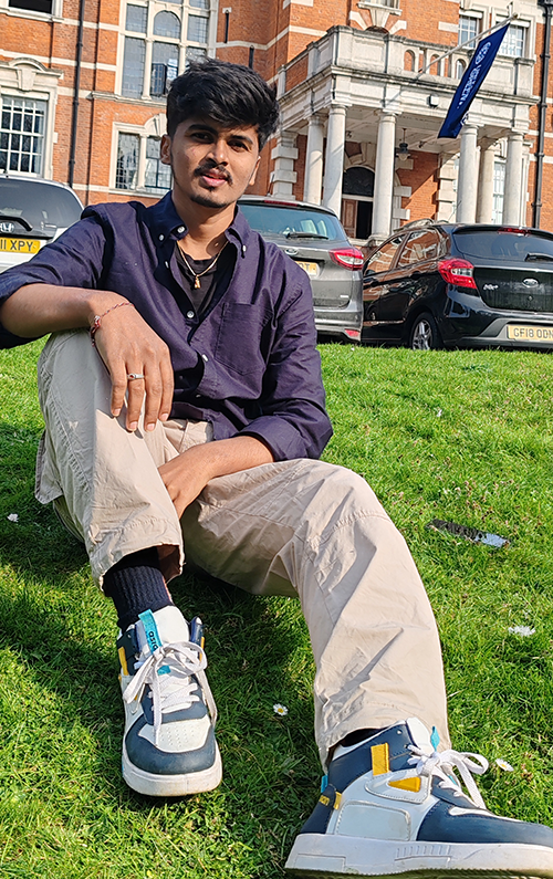 Kartheek Kundarapu sitting outside the pembroke building at the medway campus, university of greenwich